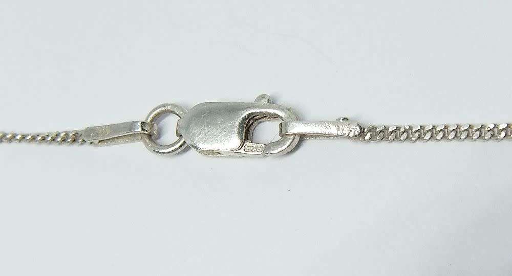 A genuine sterling silver necklace and cross pendant with faceted clear insets plus gift box