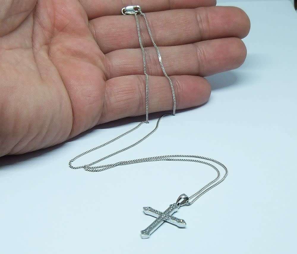 A genuine sterling silver necklace and cross pendant with faceted clear insets plus gift box