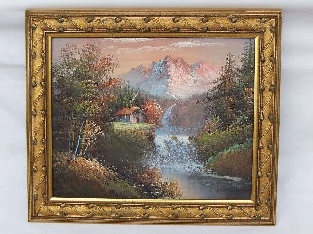 A signed oil painting depicting a forrest landscape with cottage and waterfalls