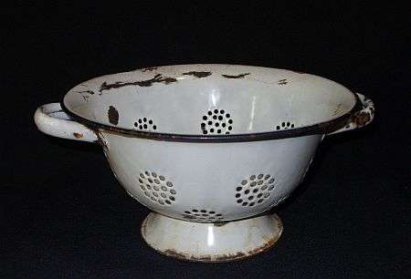 AN OLD FARM STYLE ENAMEL STRAINER