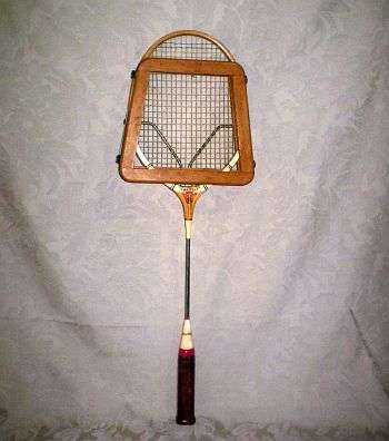 A VINTAGE DUNLOP BADMINTON RACQUET WITH ORIGINAL PROTECTOR