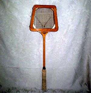 A VINTAGE DUNLOP SQUASH RACQUET WITH ORIGINAL PROTECTOR