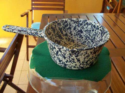 A  spotted blue enamel pot with handle