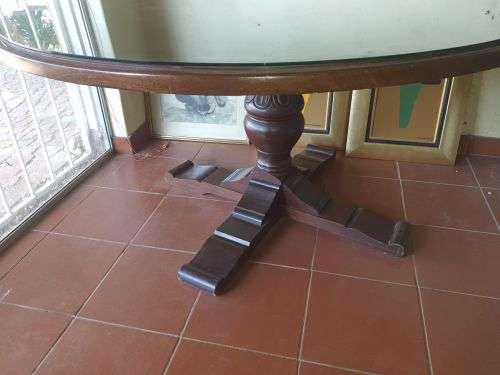 Solid oak round pedestal dining room table, with a glass table top cover.