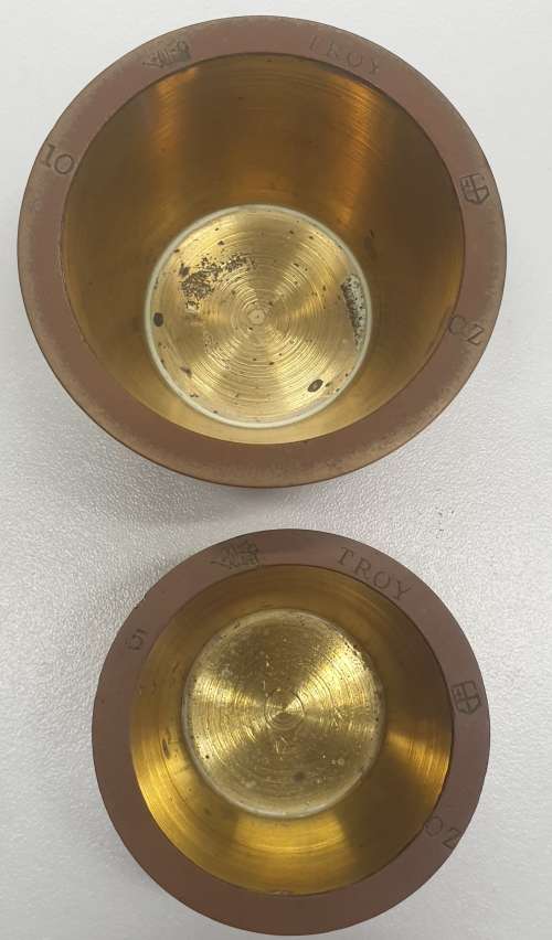 Antique 7 pce set of brass Troy ounce nesting cup weights.