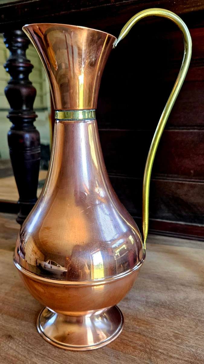 Vintage copper jug with brass rings