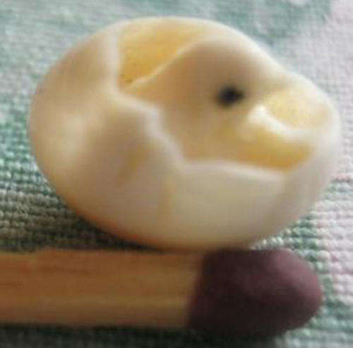 ANTIQUE, MINIATURE, HANDCARVED, IVORY EGG WITH A BABY CHICKEN SITTING INSIDE