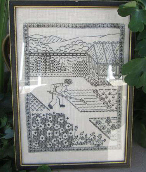 BLACK ON WHITE SAMPLER USING VARIOUS STITCHES, FRAMED BEHIND GLASS.