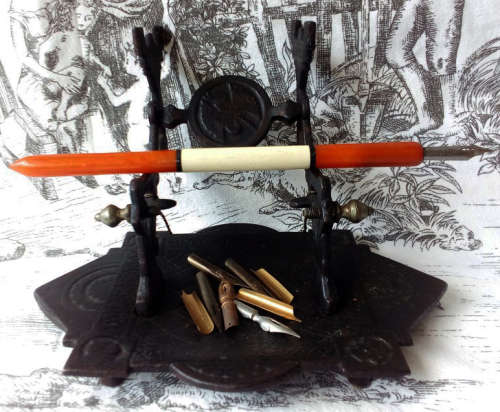 ANTIQUE, DECORATIVE CAST IRON NIB PEN REST, VINTAGE CELLULOID AND BONE DIP PEN