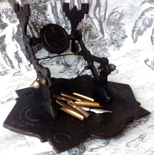 ANTIQUE, DECORATIVE CAST IRON NIB PEN REST, VINTAGE CELLULOID AND BONE DIP PEN