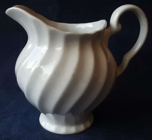 DELICATE LOOKING, WHITE JUG, MADE IN ENGLAND WITH A PRETTY SWIRLING DESIGN,