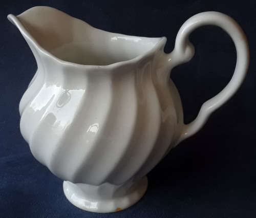 DELICATE LOOKING, WHITE JUG, MADE IN ENGLAND WITH A PRETTY SWIRLING DESIGN,