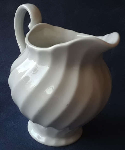 DELICATE LOOKING, WHITE JUG, MADE IN ENGLAND WITH A PRETTY SWIRLING DESIGN,