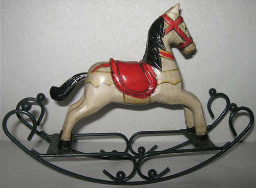 VINTAGE LOOKING HAND CARVED WOODEN ROCKING HORSE ON WROUGHT IRON ROCKER.