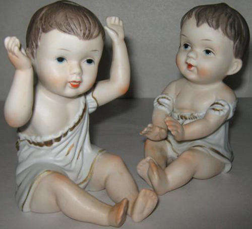 ANTIQUE HAND PAINTED BISQUE " PIANO DOLLS "  IN GOOD CONDITION.