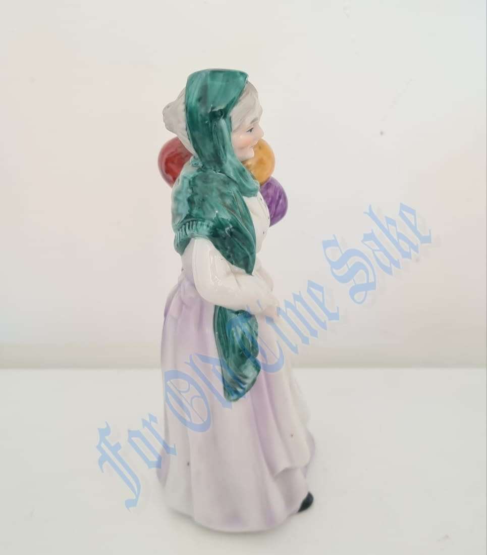 Vintage Porcelain lady with Balloons figure, no markings, she stands 19.5cmtall