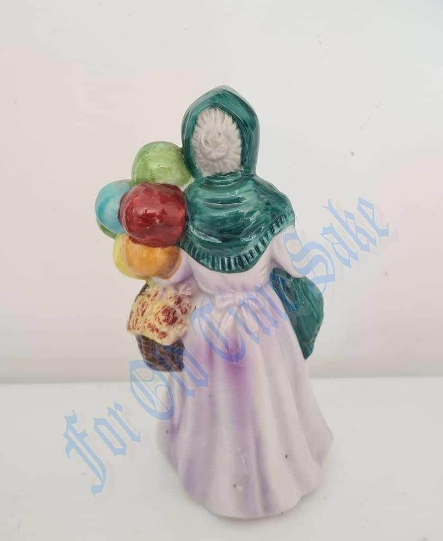 Vintage Porcelain lady with Balloons figure, no markings, she stands 19.5cmtall