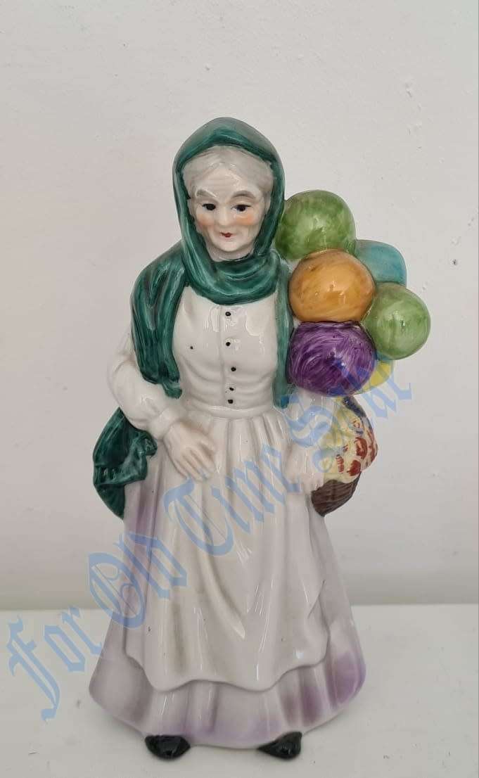 Vintage Porcelain lady with Balloons figure, no markings, she stands 19.5cmtall