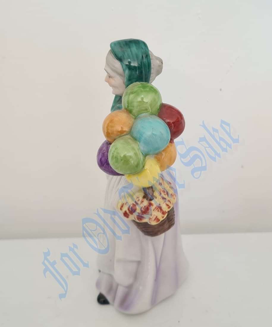Vintage Porcelain lady with Balloons figure, no markings, she stands 19.5cmtall