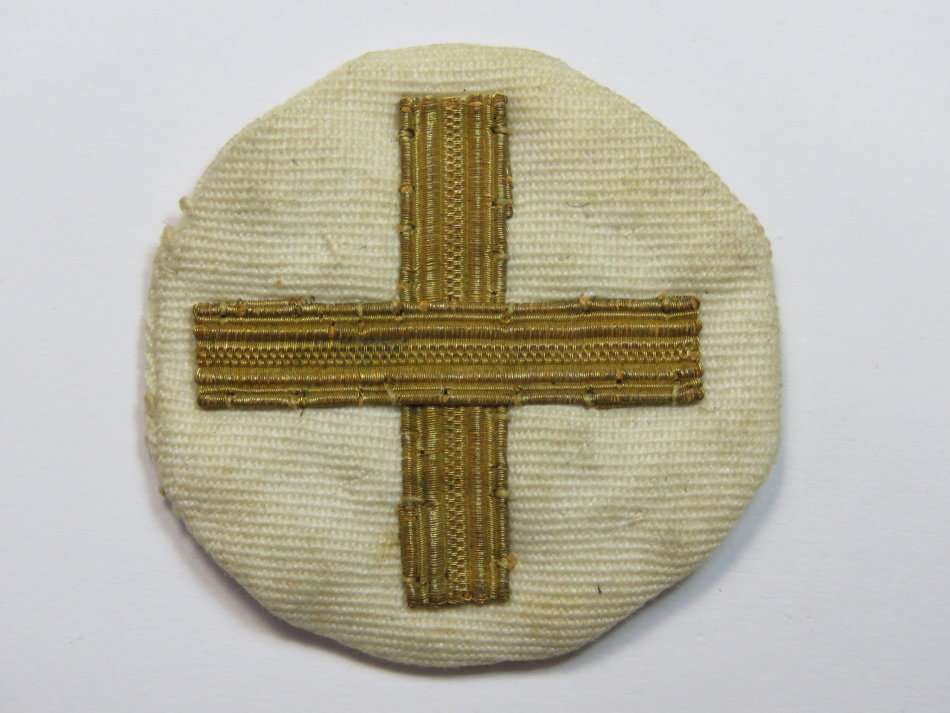 White cloth badge with gold cross - Possibly Navy