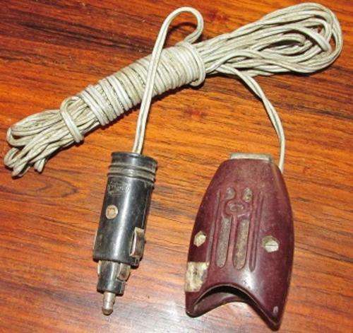 A vintage hella 12v lead light for a car