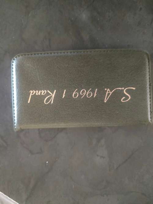 1969 English and Afrikaans R1 coins in holder.