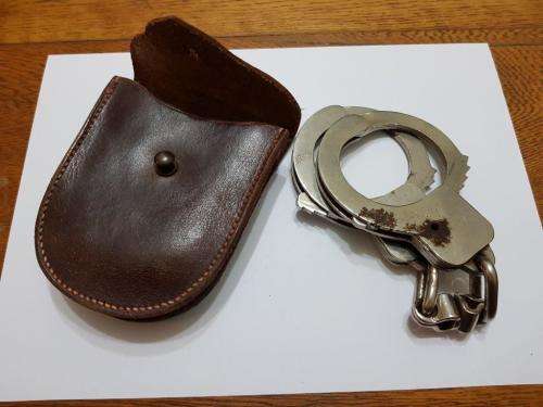 Handcuffs and leather pouch. No keys.