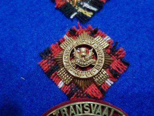 Transvaal Scottish Badges on tartan backings. All lugs intact.
