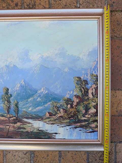 PAINTING OF A VALLEY WITH STREAM AND MOUNTAINS, SIGNED BY ARTIST.OIL ON BOARD.FRAMED