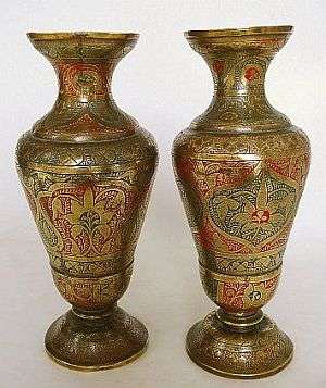 A PAIR OF ENGRAVED BRASS VASES
