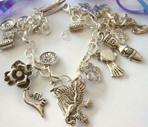 Silvertone Charm Bracelet with Glove, Dragon and Flower type Charms