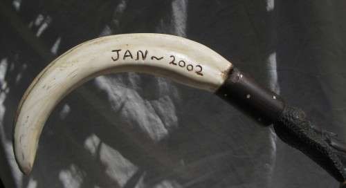 LARGE SIZED SOLID EBONY WALIKING STICK INLAID WITH BONE AND USED WARTHOG TUSK HANDLE