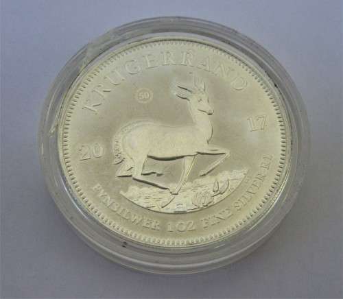 INVESTMENT~ONE OUNCE U/C 2017 FINE 999 SILVER KRUGER RAND COIN IN PLASTIC CAPSULE.