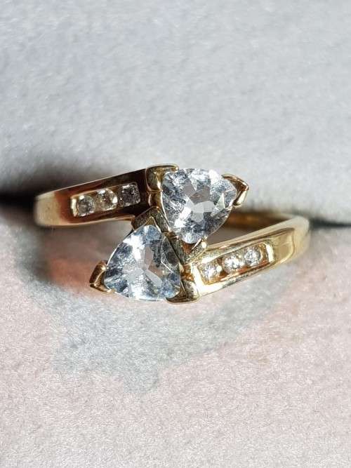 10kt Gold Aquamarine ring with 3 diamonds flanking each side