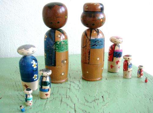 A set of vintage wooden japanese bobble head nesting dolls