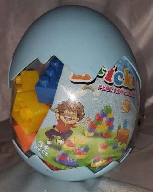 Egg shaped container with building blocks