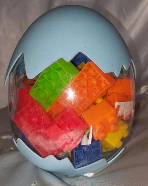 Egg shaped container with building blocks
