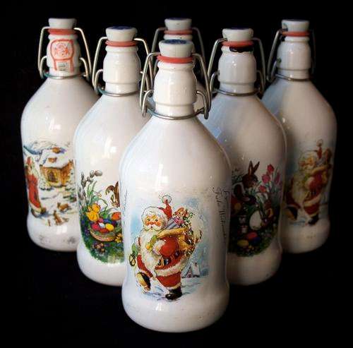 FIVE GERMAN BEER BOTTLES - THREE WITH XMAS MOTIF AND TWO WITH EASTER MOTIF