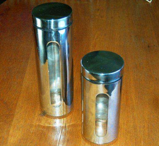 2 Stainless Steel Storage Containers with Glass inners. Tallest is 310mm Other is 230mm