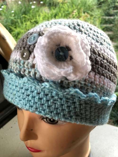 Unique handmade crochet beanie with flower and buttons detail in blue