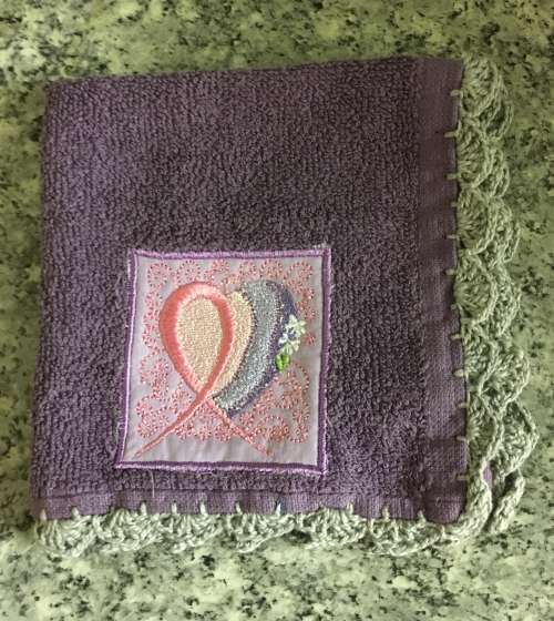 Embroidered face cloth with crochet border