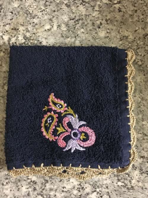 Embroidered face cloth with crochet border