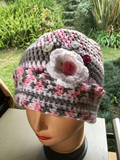 Unique handmade crochet beanie with flower and buttons detail in pink
