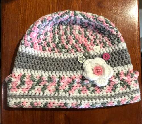 Unique handmade crochet beanie with flower and buttons detail in pink