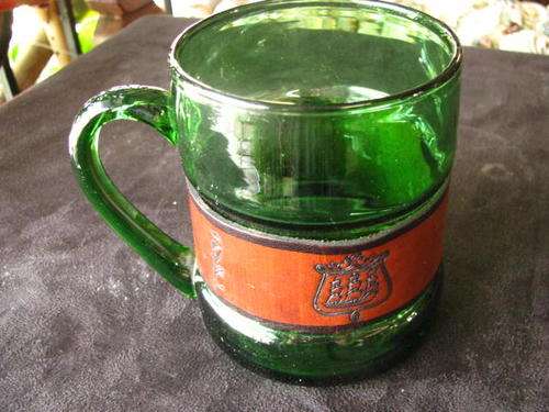 A GREEN GLASS BEER TANKARD WITH LEATHER IN THE MIDDLE