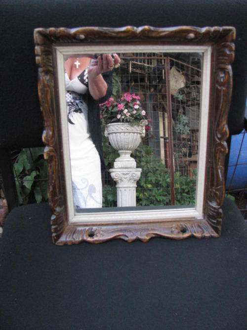 A GORGEOUS MIRROR IN ORNATE WOODEN FRAME