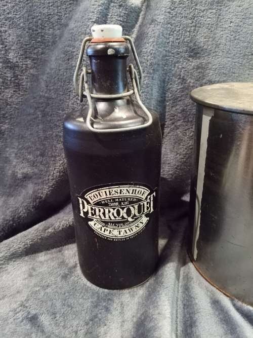 Lot including Vintage Louiesenhof Perroquet stoneware bottle and Large Crunchies tin