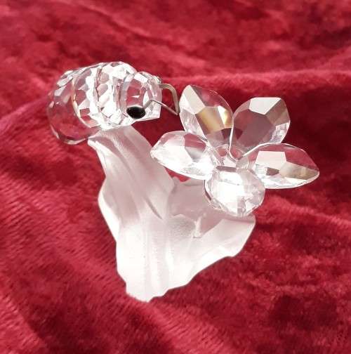 A SWAROVSKI SILVER CRYSTAL BEE WITH FLOWER