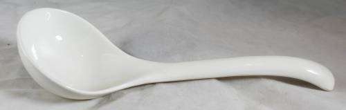 Large white serving spoon