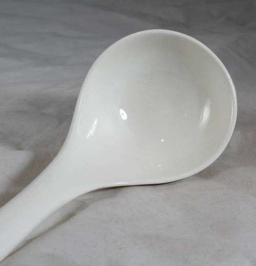 Large white serving spoon
